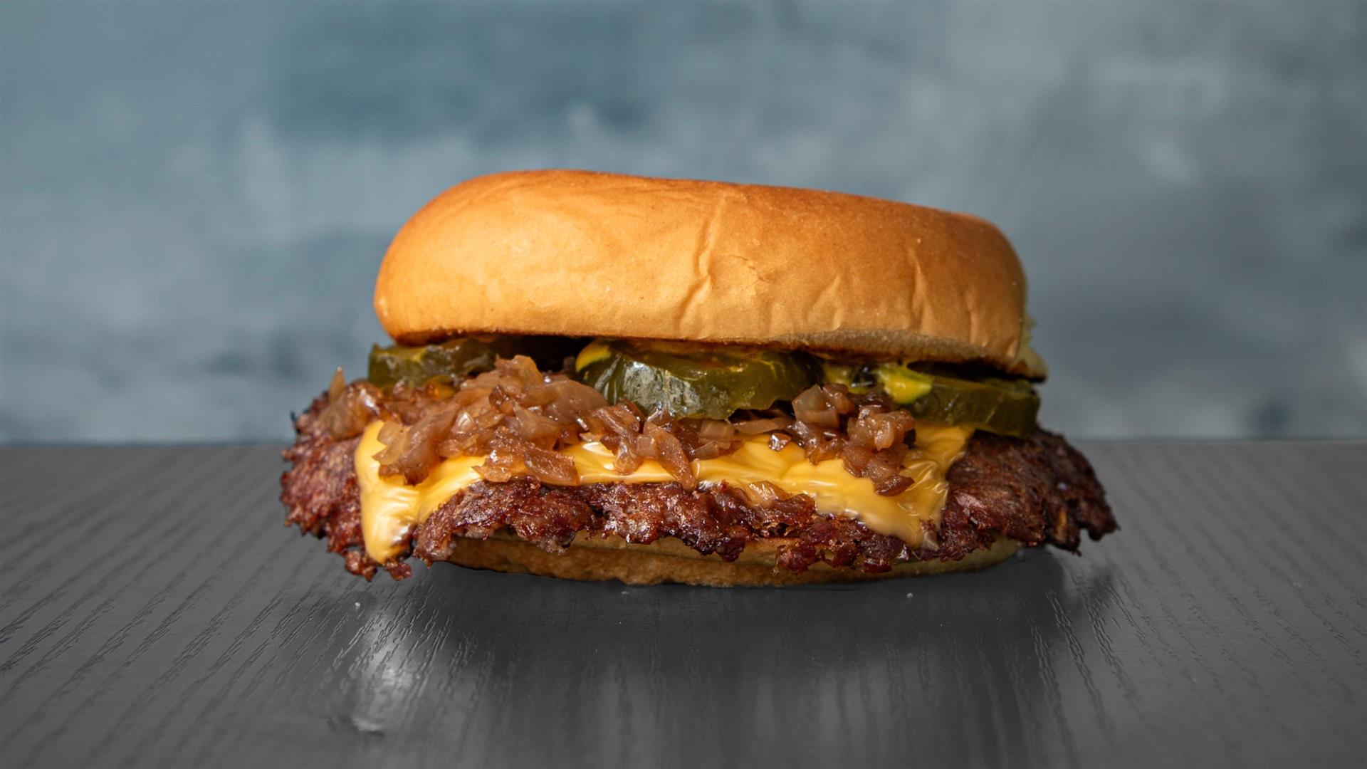 Le Burgz — smash burger cheddar, oignons confits et pickles